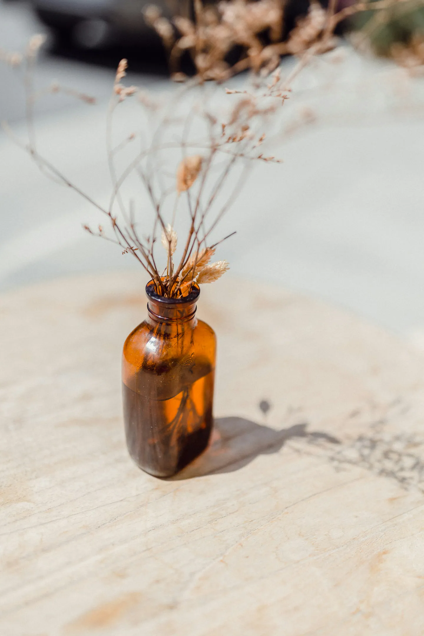 Petit flacon ambré contenant des plantes séchées